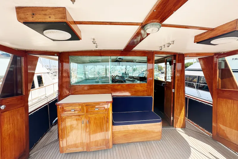 Slide: The Image of 1969 Stephens Brothers flush deck motor yacht interior with wooden cabinetry and seating. - 13