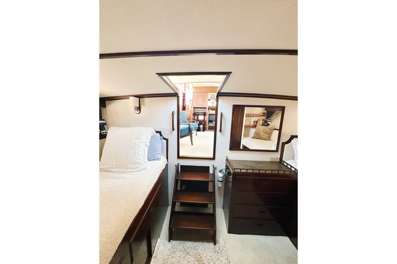 Slide: The Image of Interior of 1969 Stephens Brothers flush deck motor yacht, featuring cozy bedroom and wooden furnishings. - 15