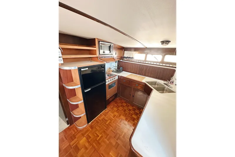 Slide: The Image of Interior of 1969 Stephens Brothers flush deck motor yacht kitchen with wood cabinetry and appliances. - 18