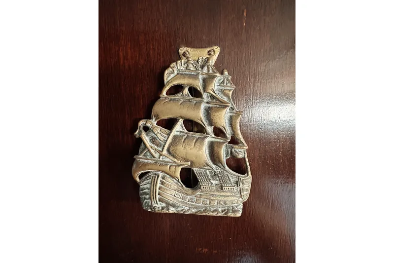 Slide: The Image of Vintage brass ship wall decor on wooden surface, 1969 Stephens Brothers yacht theme. - 19