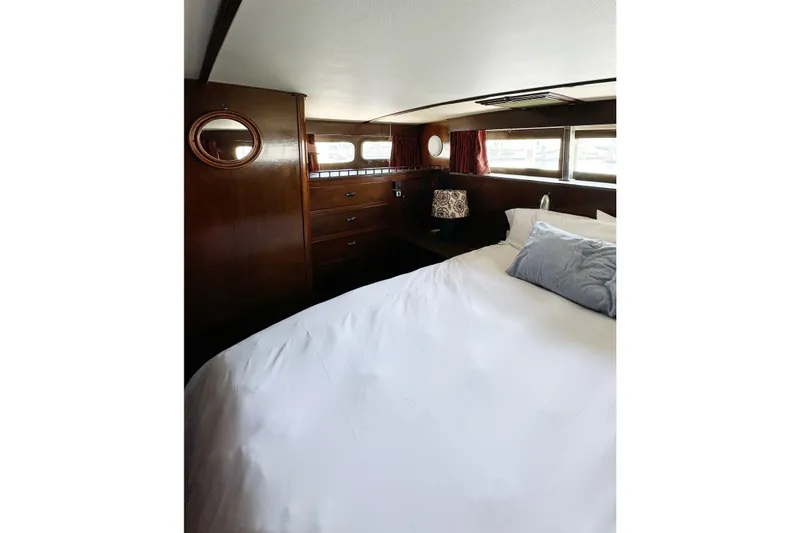 Slide: The Image of Luxurious 1969 Stephens Brothers flush deck motor yacht bedroom with elegant wood paneling. - 23