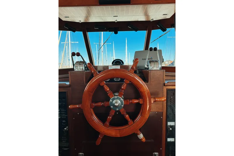Slide: The Image of Wooden helm of a 1969 Stephens Brothers flush deck motor yacht, featuring classic nautical design. - 25