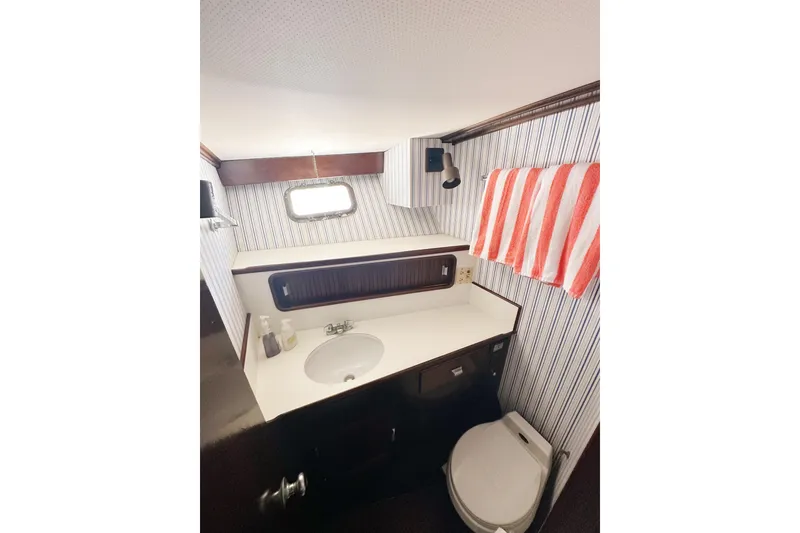 Slide: The Image of Bathroom interior of 1969 Stephens Brothers flush deck motor yacht, featuring striped walls and modern fixtures. - 29