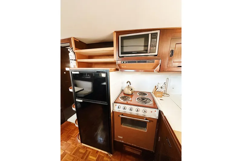 Slide: The Image of Vintage yacht kitchen with stove, microwave, and fridge; Stephens Brothers 1969 motor yacht. - 30