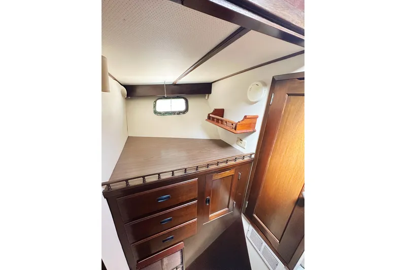 Slide: The Image of Interior of 1969 Stephens Brothers flush deck motor yacht with wooden cabinetry and porthole window. - 32