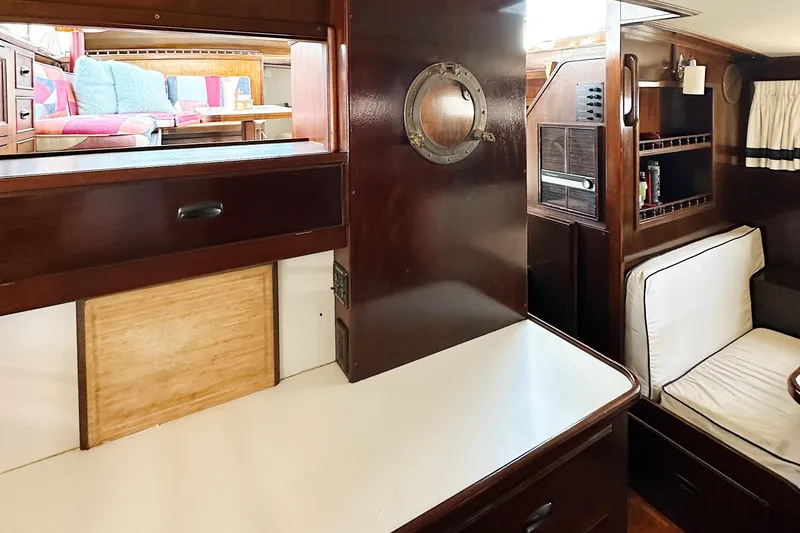 Slide: The Image of Interior of 1969 Stephens Brothers flush deck motor yacht with wood paneling and cozy seating. - 33