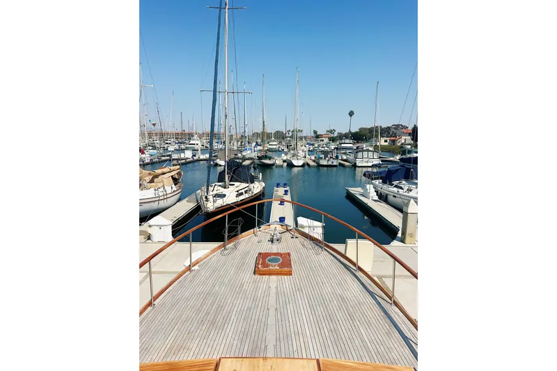 Slide: The Image of 1969 Stephens Brothers flush deck motor yacht docked in a marina, surrounded by sailboats. - 6