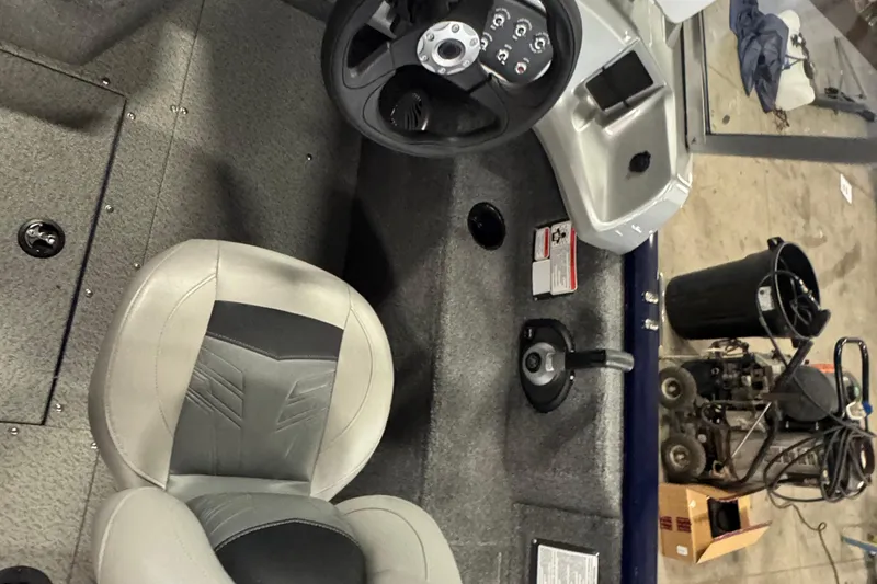 Slide: The Image of Interior of a 2019 Tracker Pro Guide V-175 Combo boat, featuring steering wheel and seat. - 6