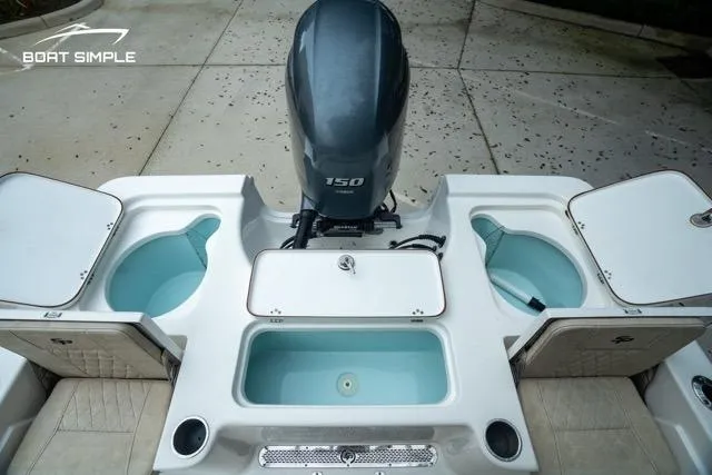 Slide: The Image of 2024 Sea Pro 208 Bay boat with Yamaha 150 engine, featuring live wells and storage compartments. - 9
