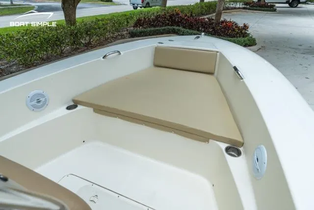 Slide: The Image of 2024 Scout 195 Sportfish boat interior with beige seating and cup holders. - 10