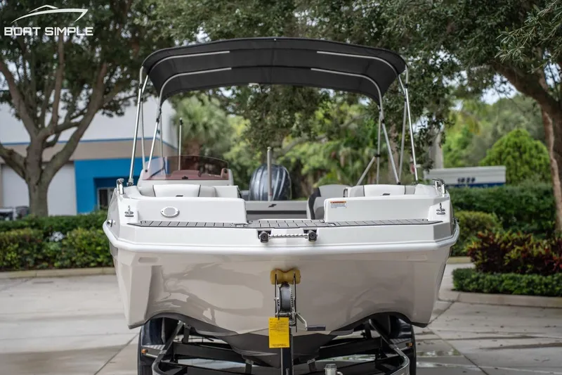 Slide: The Image of 2023 Starcraft SVX 231 OB DH boat on trailer, rear view, outdoors. - 2