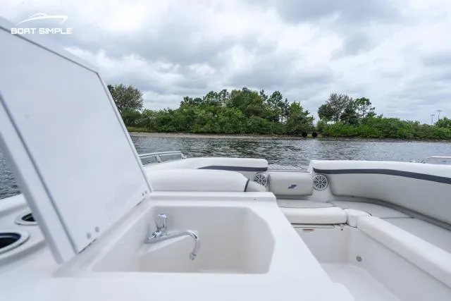 Slide: The Image of 2023 Starcraft SVX 231 OB DH boat interior with sink, open water view. - 12
