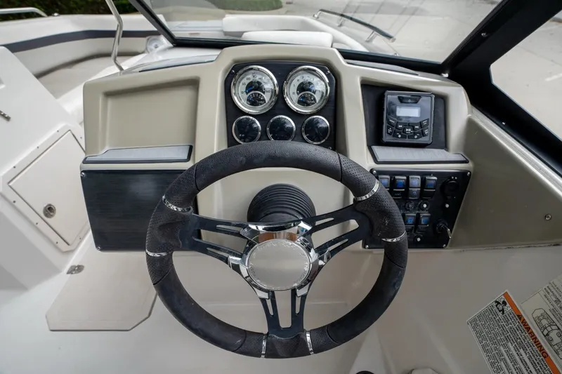 Slide: The Image of Steering console of 2022 Starcraft SVX 190 DC boat with gauges and controls. - 12