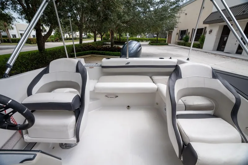 Slide: The Image of 2022 Starcraft SVX 190 DC boat interior with cushioned seating and steering wheel. - 16