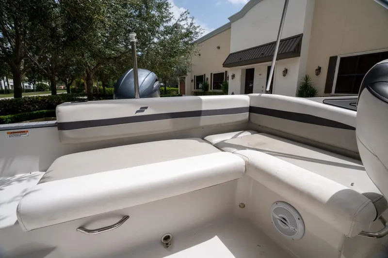Slide: The Image of 2022 Starcraft SVX 190 DC boat interior with cushioned seating and outdoor view. - 18
