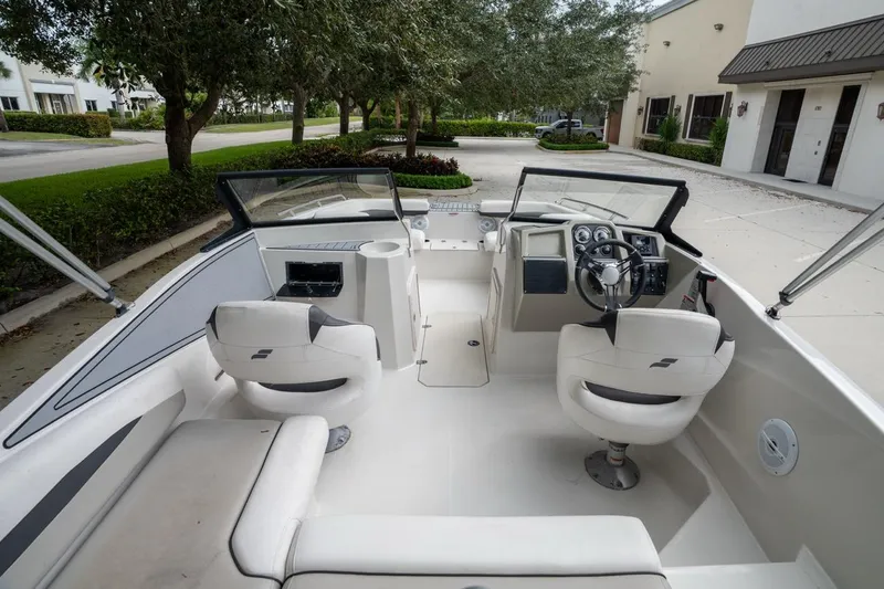 Slide: The Image of 2022 Starcraft SVX 190 DC boat interior with steering wheel and seating. - 9