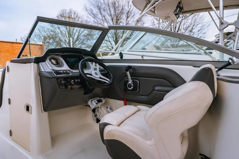 Slide: The Image of 2018 Chaparral 224 Sunesta boat interior with steering wheel and captain's seat. - 3