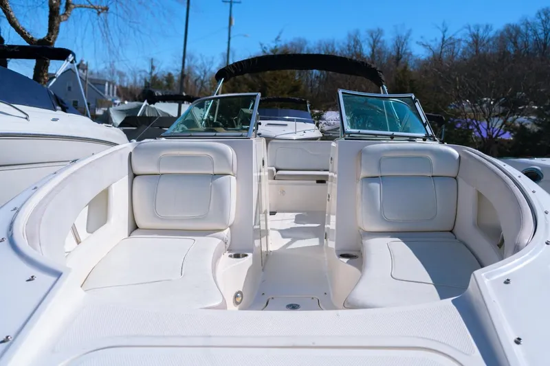 Slide: The Image of 2012 Sea Ray 240 Sundeck boat with white seating and open deck layout. - 3