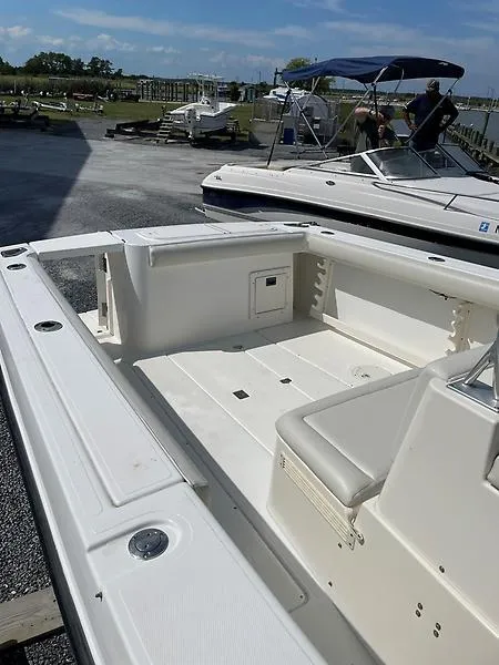 Slide: The Image of 2001 Shamrock 270 Open boat, spacious deck, docked under clear skies. - 13