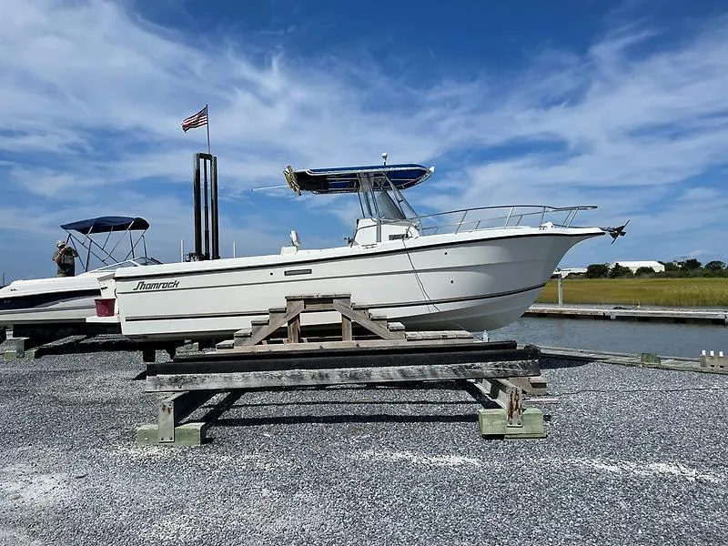 Slide: The Image of 2001 Shamrock 270 Open boat on dry dock with clear sky background. - 2