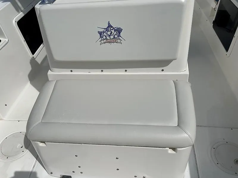 Slide: The Image of White seating on 2001 Shamrock 270 Open boat, featuring a logo on the backrest. - 22