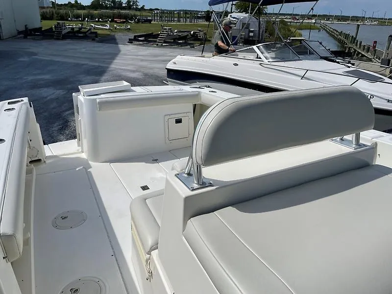 Slide: The Image of 2001 Shamrock 270 Open boat interior with white seating and storage compartments. - 23
