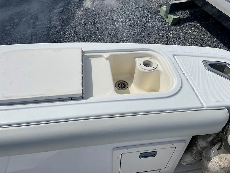 Slide: The Image of 2001 Shamrock 270 Open boat sink and storage area on deck. - 26