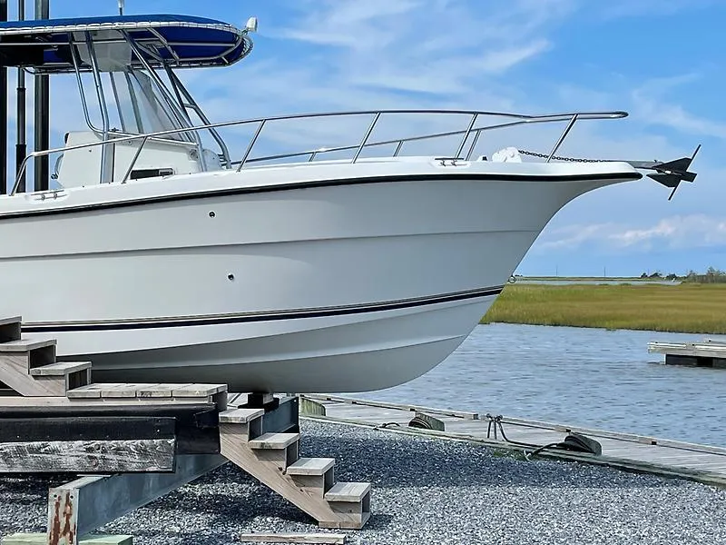 Slide: The Image of 2001 Shamrock 270 Open boat docked by the water on a sunny day. - 3