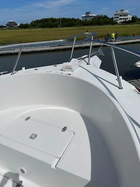 Slide: The Image of 2001 Shamrock 270 Open boat docked near waterfront homes. - 32