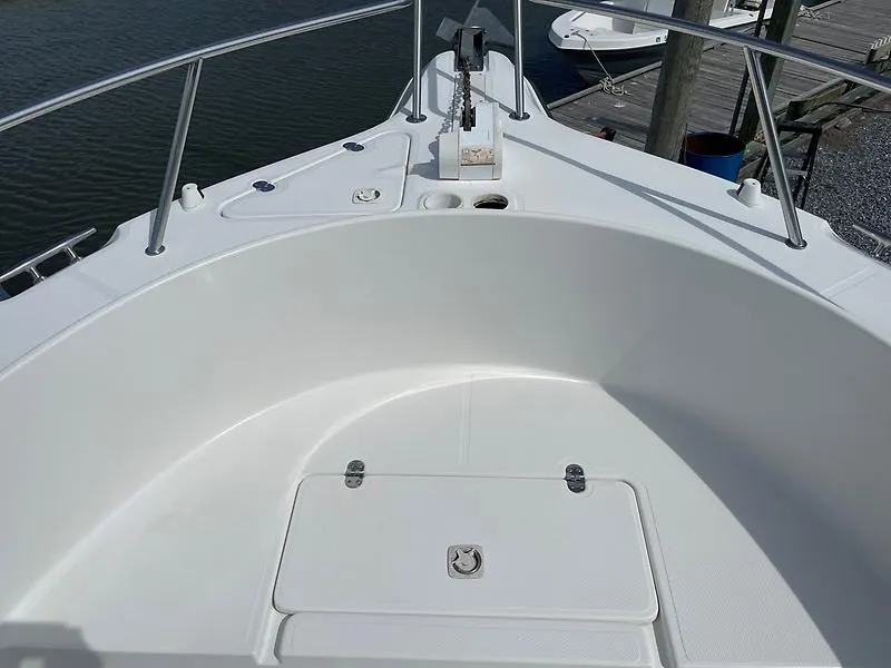 Slide: The Image of 2001 Shamrock 270 Open boat deck with anchor, railing, and storage compartment. - 33