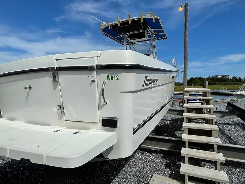 Slide: The Image of 2001 Shamrock 270 Open boat on dry dock with blue sky background. - 36