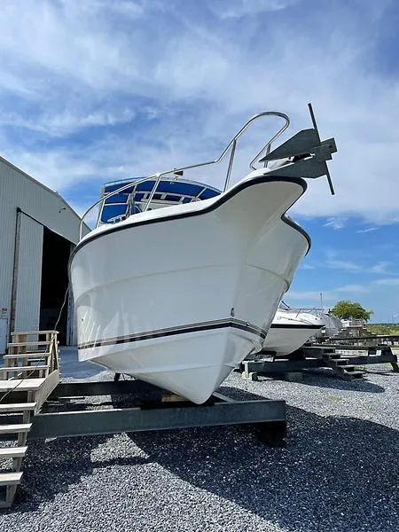 Slide: The Image of 2001 Shamrock 270 Open boat on dry dock under a clear blue sky. - 4