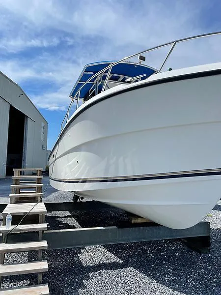 Slide: The Image of 2001 Shamrock 270 Open boat on trailer, blue sky background. - 40