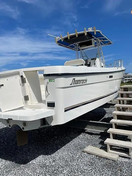 Slide: The Image of 2001 Shamrock 270 Open boat on dry dock with blue sky background. - 41