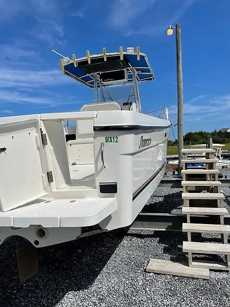 Slide: The Image of 2001 Shamrock 270 Open boat on dry dock with blue sky background. - 8