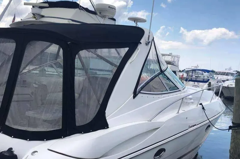 The Image of 2001 Cruisers Yachts 3470 Express in storage, side view, indoors. - 1