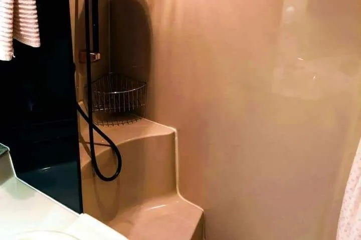 Slide: The Image of 2001 Cruisers Yachts 3470 Express bathroom with shower and beige interior. - 13