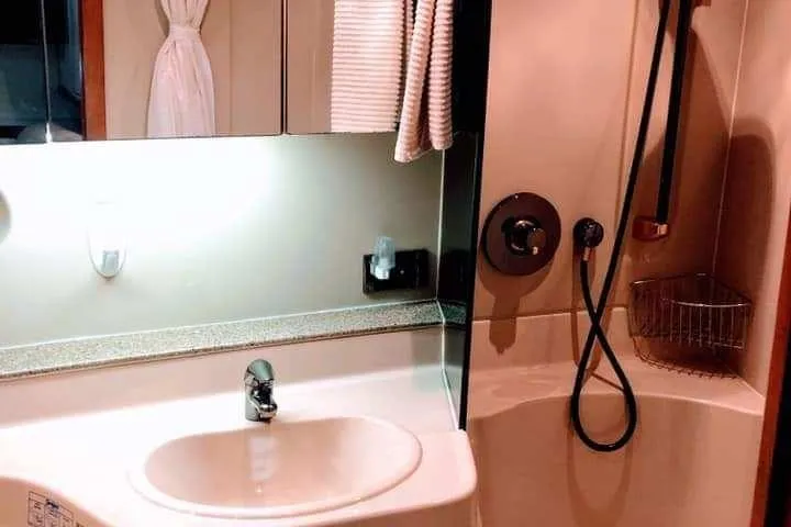 Slide: The Image of Interior of 2001 Cruisers Yachts 3470 Express with patterned seating and porthole windows. - 8