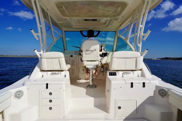 Slide: The Image of 2016 Grady-White Express 330 boat with dual engines on open water. - 15