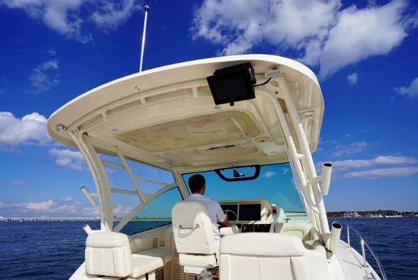 Slide: The Image of 2016 Grady-White Express 330 boat interior with helm, white seating, and ocean view. - 17