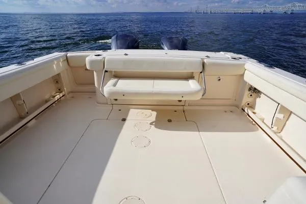 Slide: The Image of 2016 Grady-White Express 330 boat interior with helm, white seating, and ocean view. - 18