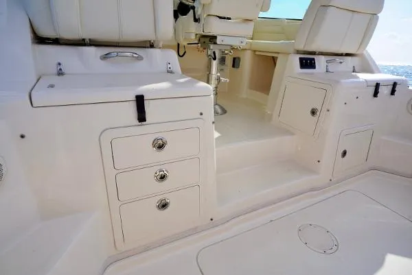 Slide: The Image of 2016 Grady-White Express 330 boat interior with storage compartments and seating. - 23
