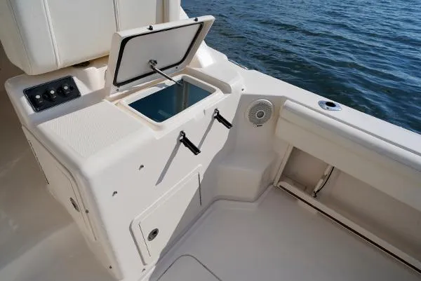 Slide: The Image of 2016 Grady-White Express 330 boat interior with open storage compartment by the water. - 24