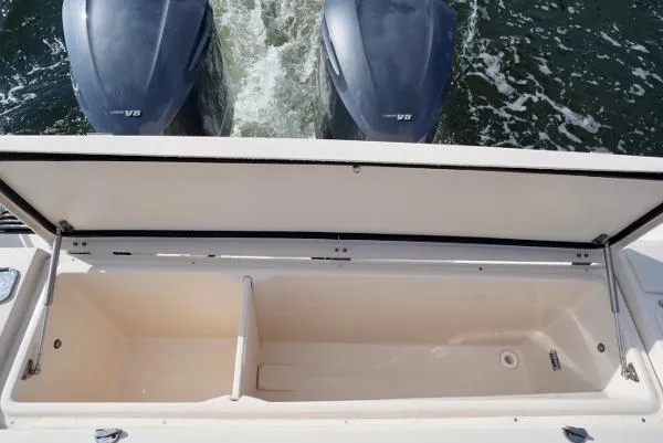 Slide: The Image of 2016 Grady-White Express 330 boat with open storage compartment and twin V8 engines. - 29