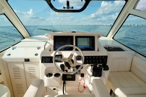 Slide: The Image of 2016 Grady-White Express 330 helm with ocean view, featuring modern navigation equipment. - 30