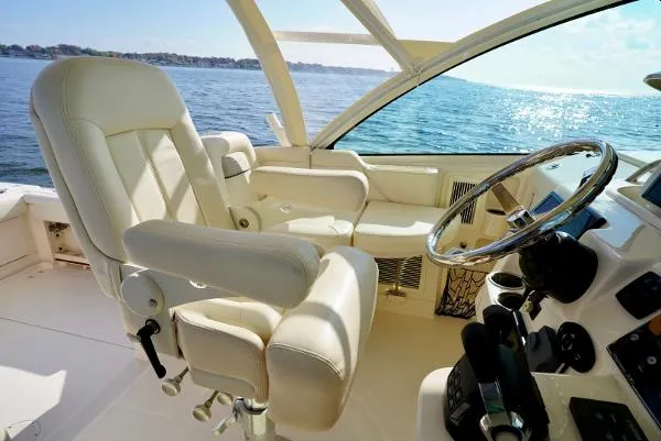 Slide: The Image of 2016 Grady-White Express 330 boat interior with helm, steering wheel, and navigation screens. - 36
