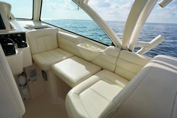 Slide: The Image of Luxurious 2016 Grady-White Express 330 boat interior with captain's chair and steering wheel. - 37