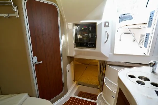 Slide: The Image of 2016 Grady-White Express 330 interior with kitchen, seating, and bed. - 39