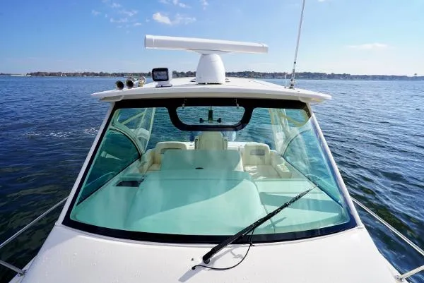 Slide: The Image of 2016 Grady-White Express 330 boat on open water, clear sky, front view. - 9