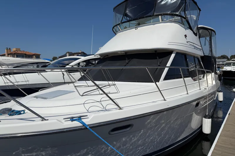 The Image of 2001 Bayliner 4087 Aft Cabin Motoryacht docked at marina under clear blue sky. - 0
